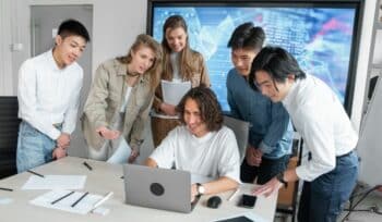 Satisfied team viewing laptop