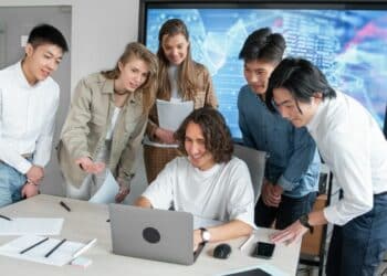 Satisfied team viewing laptop